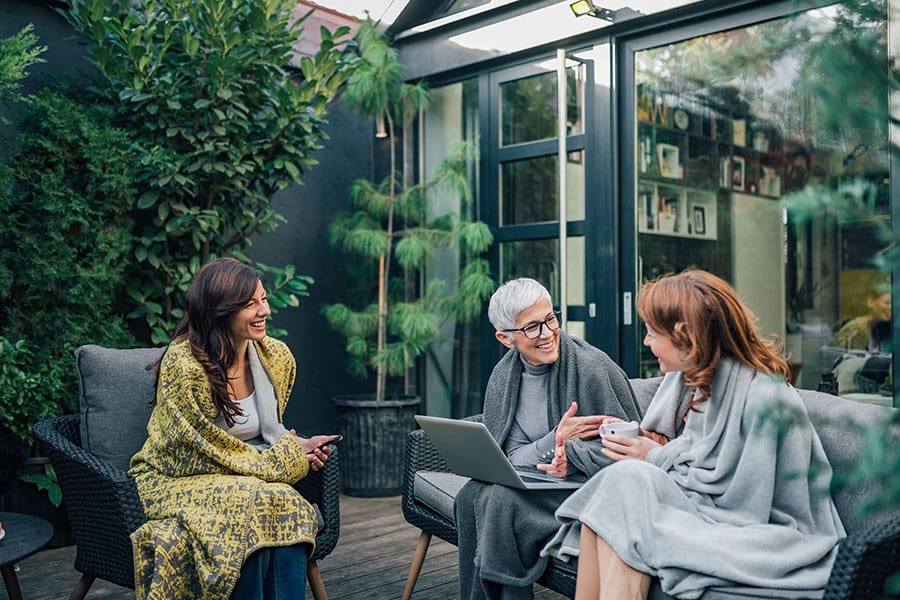 Employee Benefits - Multi Generation Family Having Fun Talking at modern backyard
